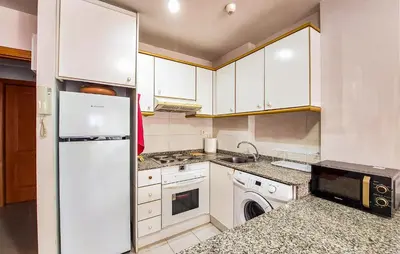 a kitchen with white cabinets and a washer and dryer at Beautiful Apartment In Canet De Berenguer in Canet de Berenguer