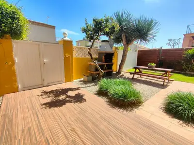 a backyard with a picnic table and a bench at VILLA ALGUER - Chalet junto a la playa del Marenyet de Cullera in Cullera