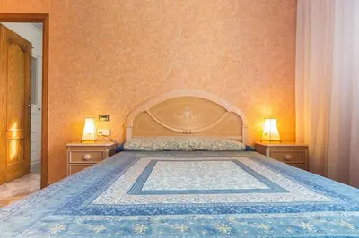 a bedroom with a large bed with two night stands at VILLA ALGUER - Chalet junto a la playa del Marenyet de Cullera in Cullera