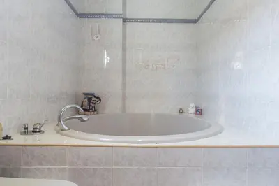 a bathroom with a large tub in a room at VILLA ALGUER - Chalet junto a la playa del Marenyet de Cullera in Cullera