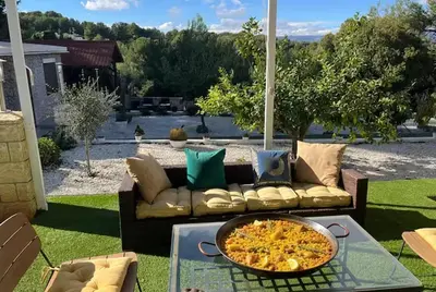 a group of people doing yoga on the roof of a house at Villa Jazmín - Piscina - BBQ - Jardín - Chill out in Masía Aldamar