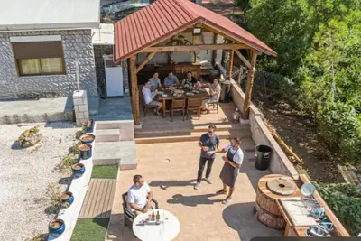 a group of people standing on a patio at Villa Jazmín - Piscina - BBQ - Jardín - Chill out in Masía Aldamar