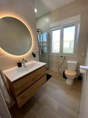 a bathroom with a sink and a toilet and a mirror at Bright & Quiet Apartment Close to Central Valencia in Valencia