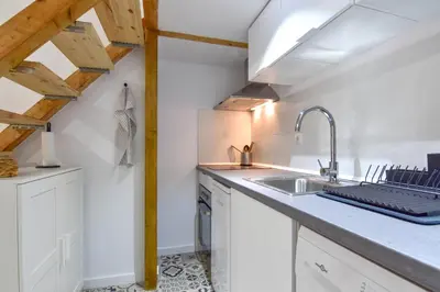 a kitchen with white cabinets and a sink at Alójate en el Puerto de Valencia 1 in Valencia