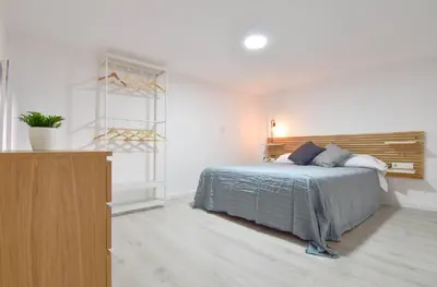 a bedroom with a bed and a dresser in it at Alójate en el Puerto de Valencia 1 in Valencia