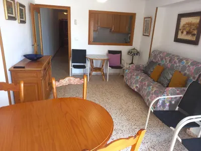 a living room with a couch and a table at Sol, 3-20 in Cullera