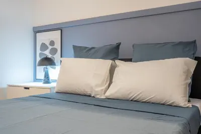 a bedroom with a bed with white pillows at Maritim Loft Apartment in Valencia