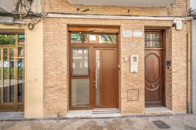 a brick building with two wooden doors on it at Maritim Loft Apartment in Valencia