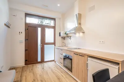 a kitchen with a wooden counter top and a sink at Maritim Loft Apartment in Valencia