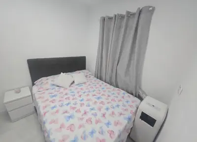 a small bedroom with a bed with an ipoduclear at AVENIDA DEL CID Alojamiento in Valencia