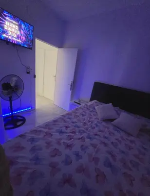 a bedroom with a bed and a tv on the wall at AVENIDA DEL CID Alojamiento in Valencia