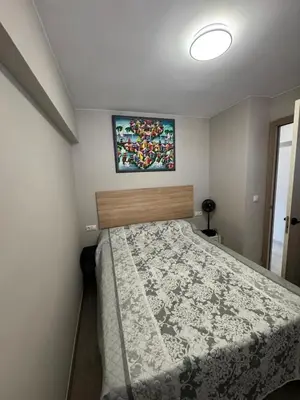 a bedroom with a bed and a tv on the wall at apartamento con vistas en la playa de San Antonio in Cullera