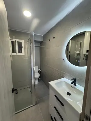 a bathroom with a sink and a mirror and a toilet at apartamento con vistas en la playa de San Antonio in Cullera