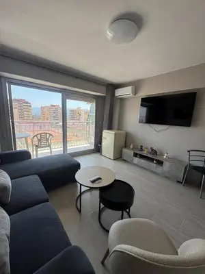 a living room with a couch and a table at apartamento con vistas en la playa de San Antonio in Cullera