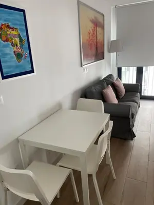 a living room with a white table and a couch at New luxury studio in the city center in Valencia