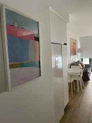 a living room with a painting on the wall at New luxury studio in the city center in Valencia