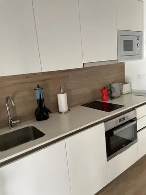 a kitchen with white cabinets and a sink at New luxury studio in the city center in Valencia