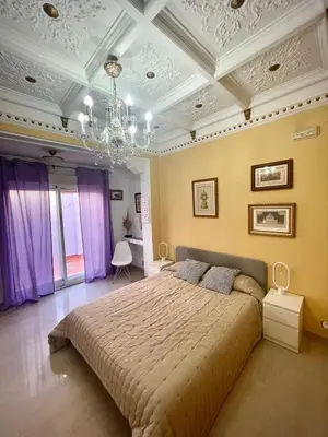 a bedroom with a large bed and a chandelier at luxury home vip valencia in Valencia