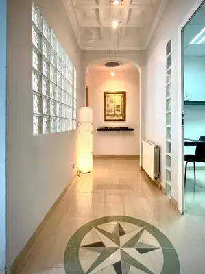 a hallway with a table and a painting on the wall at luxury home vip valencia in Valencia