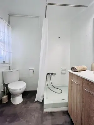 a white bathroom with a toilet and a shower at Cerca de Playa arenas con balcon in Valencia
