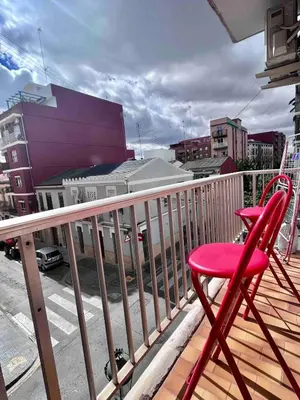 a red chair sitting on top of a balcony at Cerca de Playa arenas con balcon in Valencia