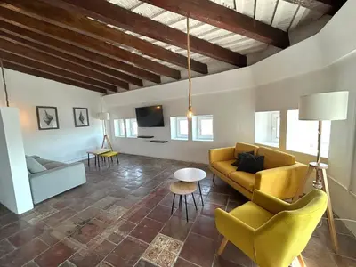 a room with stairs and a mirror on the wall at AmazINN Places Casa Calabuig Valencia Puerto - No Ascensor - in Valencia