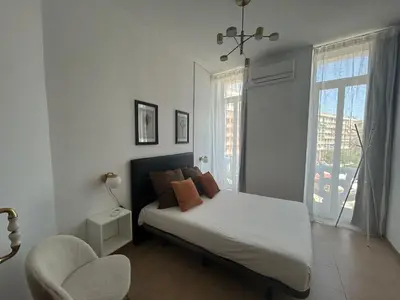 a living room with a couch and a bed at AmazINN Places Casa Calabuig Valencia Puerto - No Ascensor - in Valencia