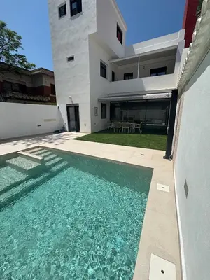 a house with a swimming pool in front of a house at Casa con PISCINA y CINE in Paterna
