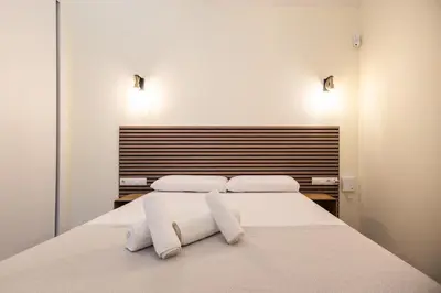 a bedroom with a bed with two towels on it at Benimamet Suite by Concept Flats in Valencia