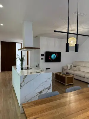 a kitchen and living room with a marble counter top at Casa Rural con piscina privada en casco urbano de Náquera Botigueta 25 in Náquera