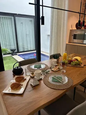 a wooden table with plates of food on it at Casa Rural con piscina privada en casco urbano de Náquera Botigueta 25 in Náquera