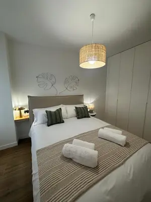 a bedroom with a large white bed with two pillows at Casa Rural con piscina privada en casco urbano de Náquera Botigueta 25 in Náquera