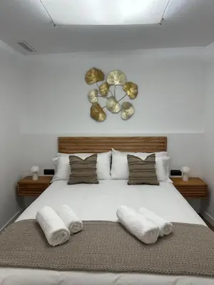a bedroom with a white bed with two towels on it at Casa Rural con piscina privada en casco urbano de Náquera Botigueta 25 in Náquera