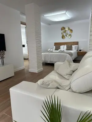 a white bedroom with two beds and a couch at Casa Rural con piscina privada en casco urbano de Náquera Botigueta 25 in Náquera