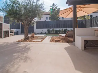 a patio with a tree and an umbrella at MD Villa Barraques de Lluna in Valencia