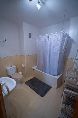 a bathroom with a toilet and a tub with a shower at Piso Playa de Canet in Canet de Berenguer