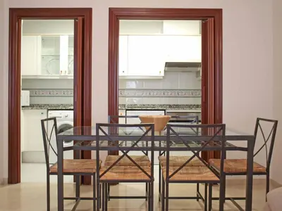 a dining room with a glass table and chairs at L'Umbracle Views in Valencia
