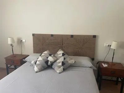 a bedroom with a bed with two night tables and two lamps at Ca Ona in Chella