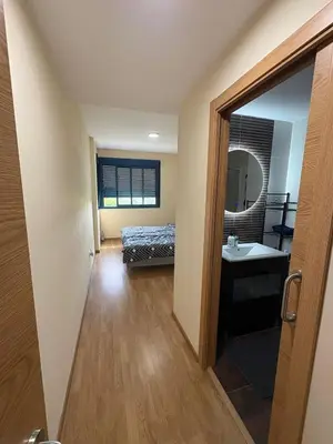 a bedroom with a bed and a sink and a mirror at Seira Apartment in Burriana