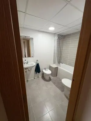 a bathroom with a toilet and a tub and a sink at Seira Apartment in Burriana