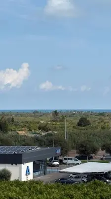 a gas station with cars parked in a parking lot at Seira Apartment in Burriana