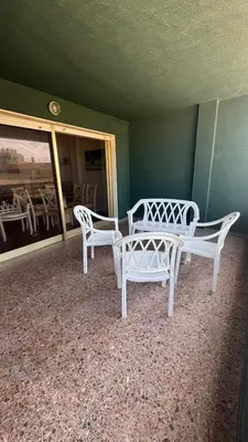 two white chairs and a table in a room at Apartamento entero Playa Perello Valencia in El Perelló
