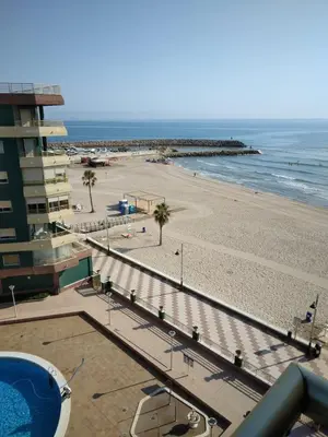 a view of the beach from the balcony of a condo at Apartamento entero Playa Perello Valencia in El Perelló