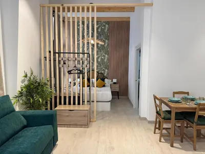 a living room with a bed and a table at Apartamento El Rincón de Darío in Valencia