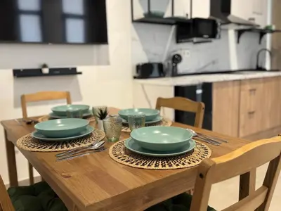 a wooden table with plates and utensils on it at Apartamento El Rincón de Darío in Valencia