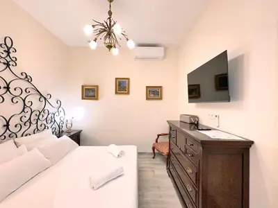 a bedroom with a bed and a dresser with a mirror at Urban Style in Valencia