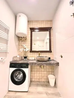 a bathroom with a sink and a washing machine at Urban Style in Valencia
