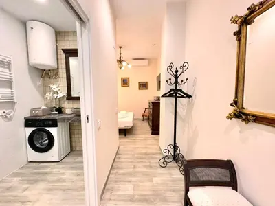 a hallway leading to a kitchen and a laundry room at Urban Style in Valencia
