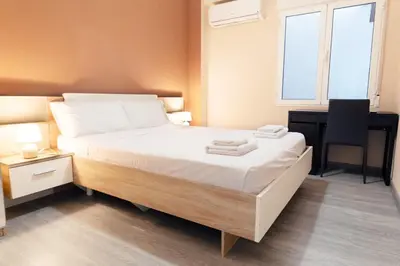 a bedroom with a bed with a desk and a chair at GuestReady - Spacious City Haven in Valencia in Valencia
