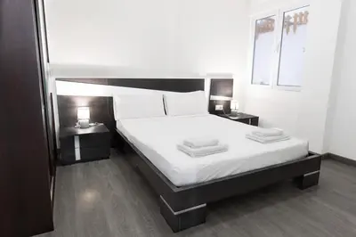 a bedroom with a large white bed with two tables at GuestReady - Spacious City Haven in Valencia in Valencia